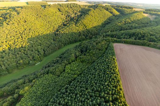 Aerial view at a landscape in Germany, Rhineland Palatinate near Bad Sobernheim with the river Nahe, meadow, farmland, forest, hills, mountains 