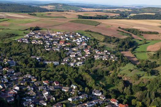 Aerial view at a landscape in Germany, Rhineland Palatinate near Bad Sobernheim with the river Nahe, meadow, farmland, forest, hills, mountains 