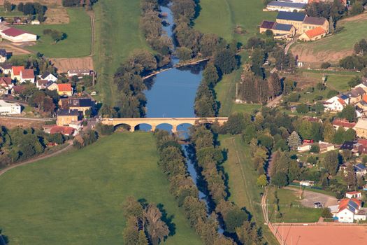 Aerial view at a landscape in Germany, Rhineland Palatinate near Bad Sobernheim with the river Nahe, the bridge in Staudernheim, meadow, farmland, forest, hills, mountains 