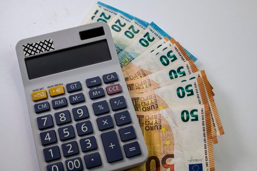 50 and 20 euro banknotes with calculator on white background