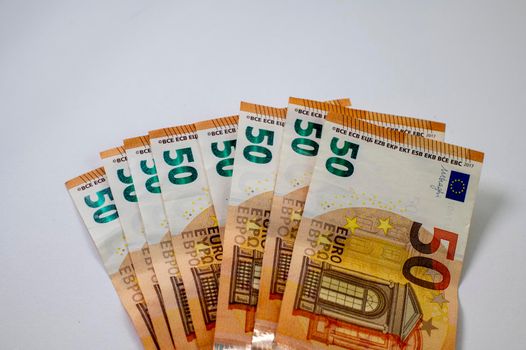 50 euro banknotes fanned out on a white background