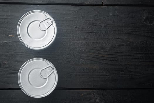 Canned sauce tin can, on black wooden background, top view or flat lay with copy space for text