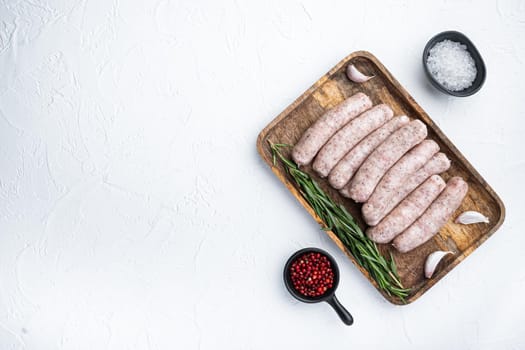 Homemade chicken meat sausages, top view with space for text, on white background.