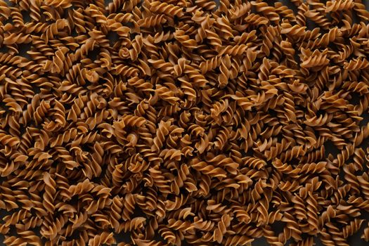 Top view of dark buckwheat pasta in dark key. High quality photo