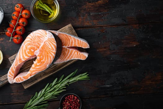 Fesh raw salmon fillet with herbs, on old wooden table, top view with space for text.