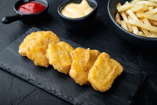 Nuggets breaded on black background.