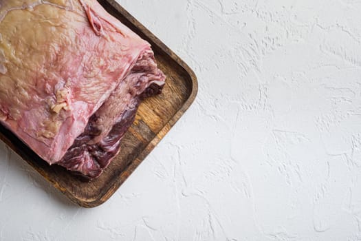 Striploin steak raw beef butchery cut, on white background, top view, with copy space for text
