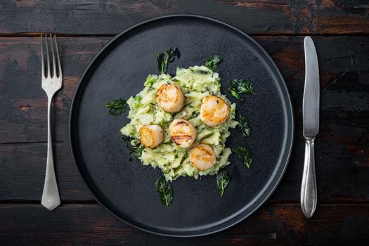 Sea delicacies, scallops cooked with minty puree, flat lay, on dark wooden background