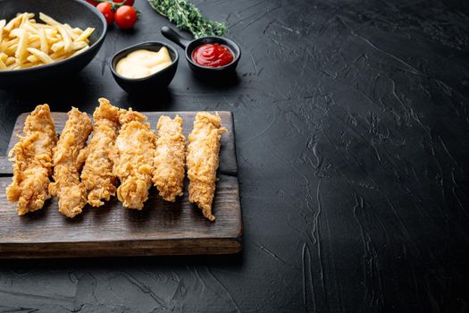 Chicken breaded wingshell meat on black background, with copy space.