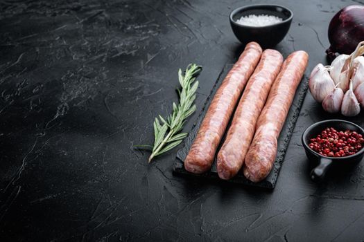 Beef sausages with space for text, on black background.