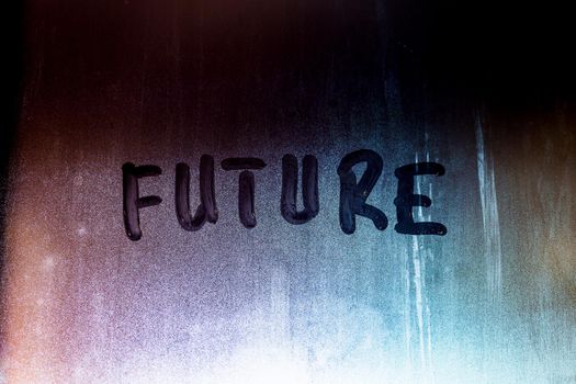 word future handwritten on night foggy window glass surface, close-up with selective focus