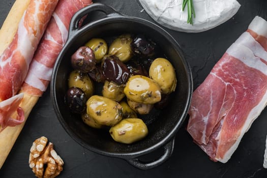 Mediterranean fresh olives, on black background, flat lay