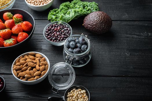 Health food with immune boosting with space for text, on black wooden background.