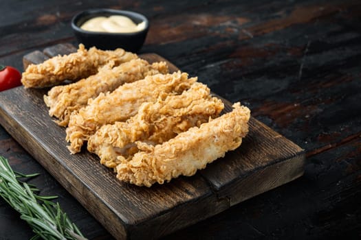 Chicken breaded wingshell meat on old dark wooden table, with copy space.