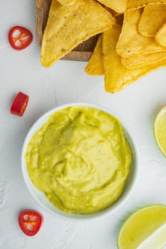 Guacamole freshly cooked and served in bowl, on white background, top view or flat lay