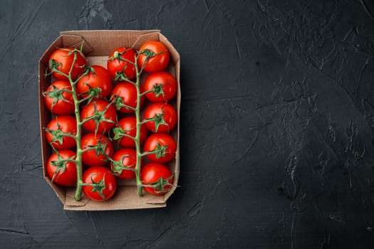 Ripe cherry tomatoes, on black background, flat lay with copy space for text