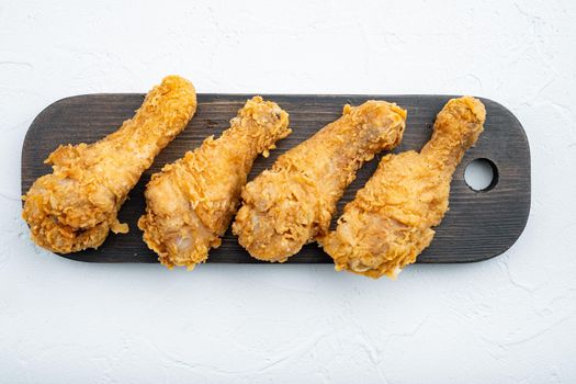 Crispy fried chicken cuts on white background.