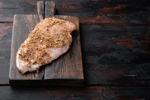 Crispy garlicky chicken raw ingredient, on wooden table with copy space