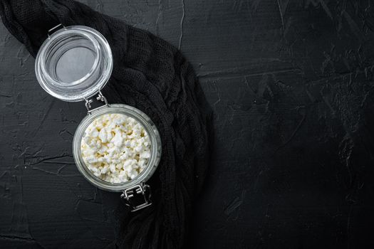 Cottage cheese, curd, on black textured background, flat lay with space for text