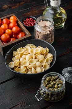 Whole wheat pasta with dried tomatoes and tuna ingredient, on old wooden table