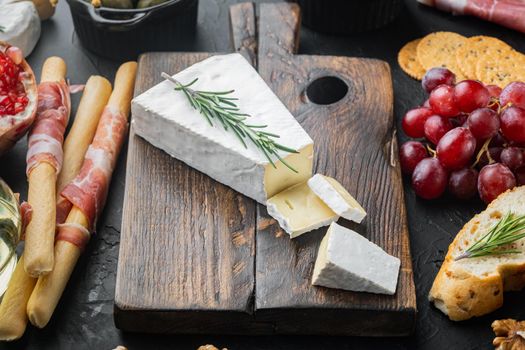 Slice of brie farmhouse creamy soft cheese set, on black background