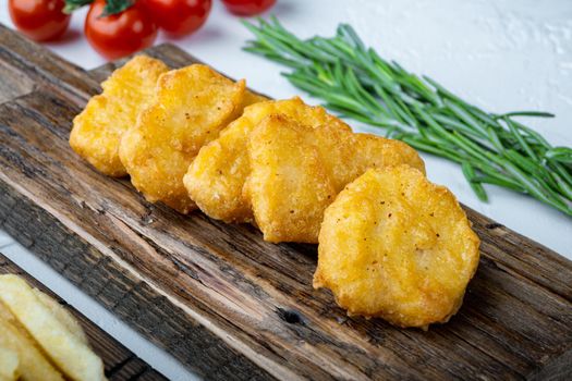 Homemade chicken nuggets fried on white background.