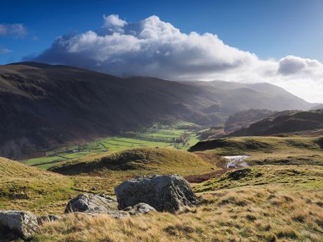 View from High Rigg over St Johns in the Vale under a blue and cloudy sky, Lake District, UK