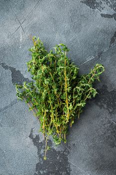 Thyme green organic bunch of herb, on gray background, top view