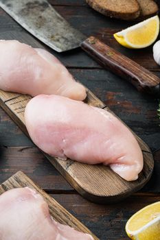 Crispy garlicky chicken raw ingredient, on dark wooden background