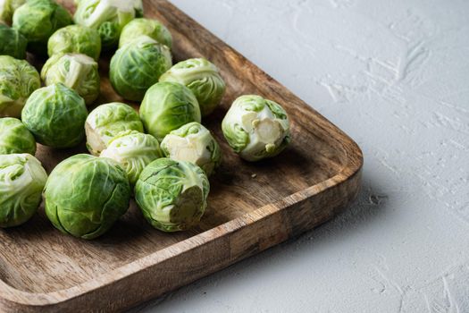Raw brussels sprouts, on white textured background