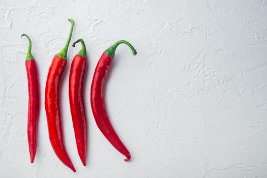 Ripe red chili peppers set, on white background, top view or flat lay with copy space for text