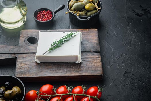 Fresh greek feta cheese set, on black background with copy space for text