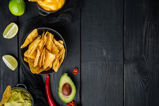 Different dips and sauces for nacho, on black wooden background, top view or flat lay with copy space for text