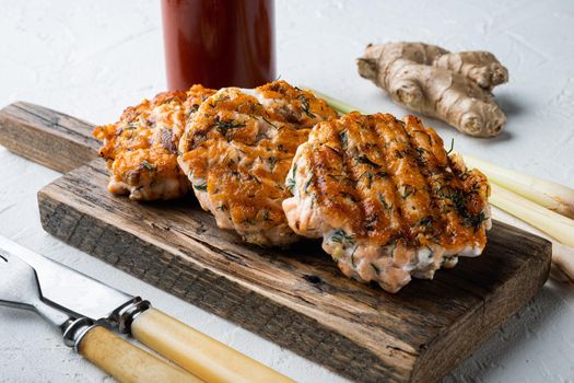 Grilled quick asian salmon cutlet, on white textured background