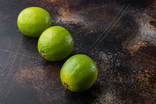Ripe green lime set, on old dark rustic background