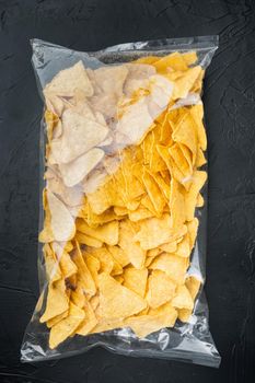 Package corn chips set, on black background, top view or flat lay