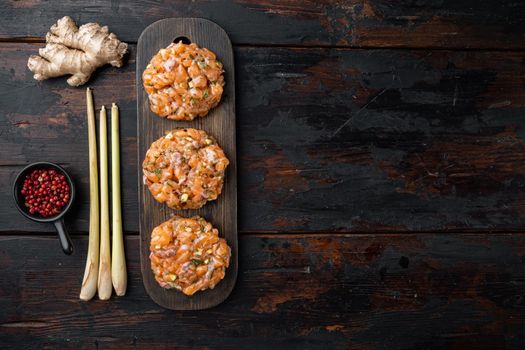 Quick asian raw fish patties with herb, on old wooden table, flat lay with space for text