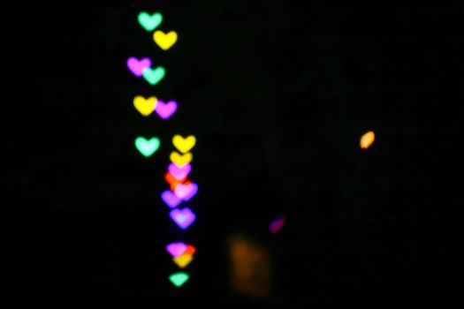 rainbow bokeh and blur line heart shape love valentine day night light in the garden