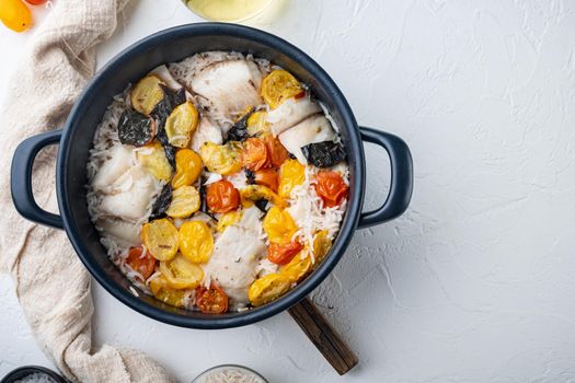 One pan fabulous fish, with basmati rice and cherry tomatoes, on white background, top view