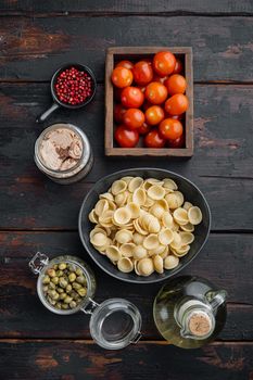 Pasta with vegetables and tuna ingredient, on old wooden table, flat lay