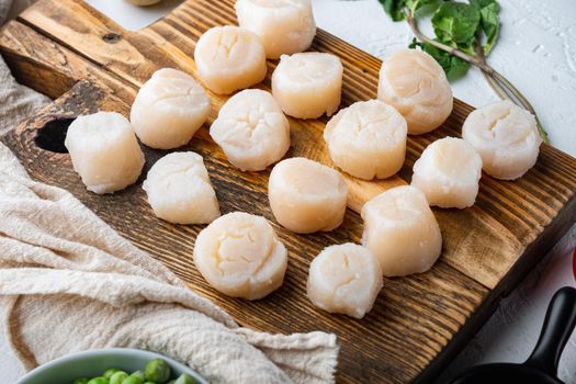 Raw fresh scallops meat, on white textured background