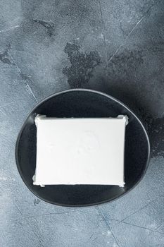 Traditional greek feta cheese set, on gray background, flat lay with copy space for text