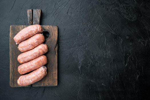 Traditional mest sausages, flat lay with space for text, on black background.
