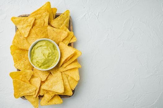 Mexican food concept. Nachos - yellow corn totopos chips with various sauce, on white background, top view or flat lay with copy space for text