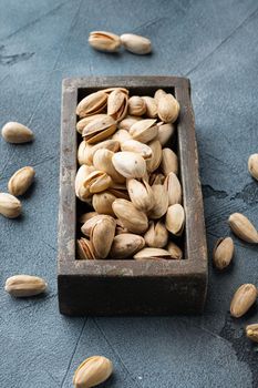 Shelled, unsalted pistachios, on grey background