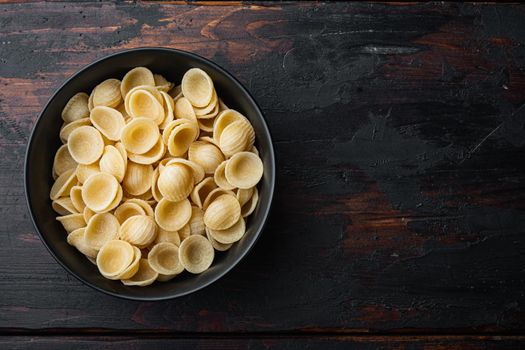 Durum wheat semolina pasta, on old wooden table, top view with copy space for text