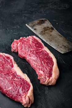 Strip steak, marbled beef raw meat, on black background