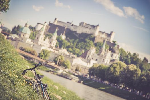 Panoramic city landscape of Salzburg in Summer, Bicycle in the foreground.