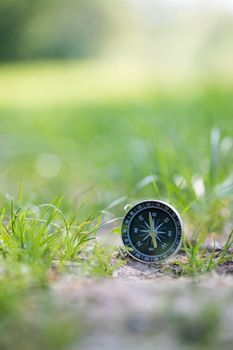 Vintage compass lying on the floor. Adventure and discovery concept.