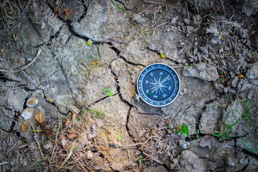 Vintage compass lying on the floor. Adventure and discovery concept.